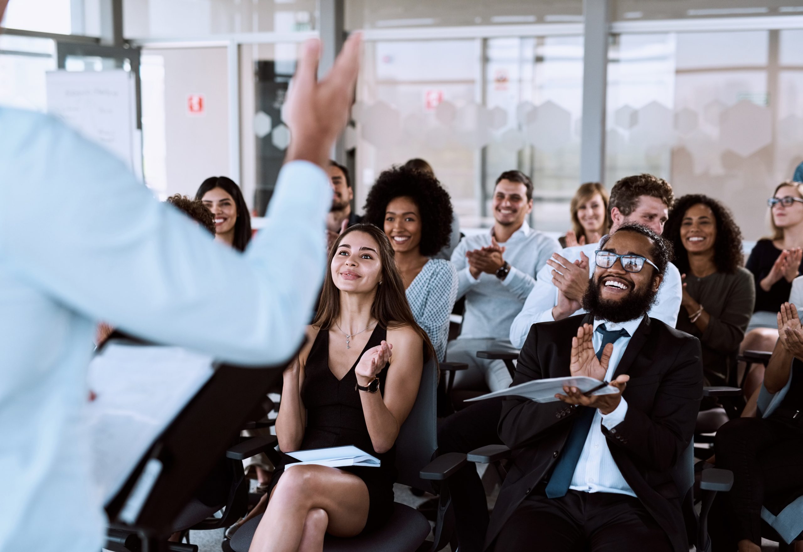 Audience applauding during presentation